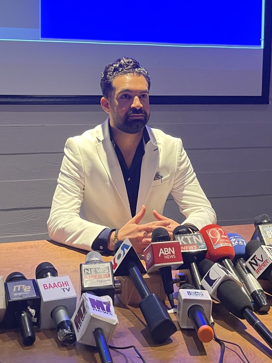Amir Shurrab at a press conference behind a wall of news microphones - VOA, ABN News, KTN News, 92 News and more